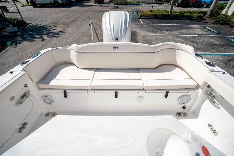 Slide: The Image of 2025 Sea Hunt Ultra 255 SE boat interior with white cushioned seating. - 10