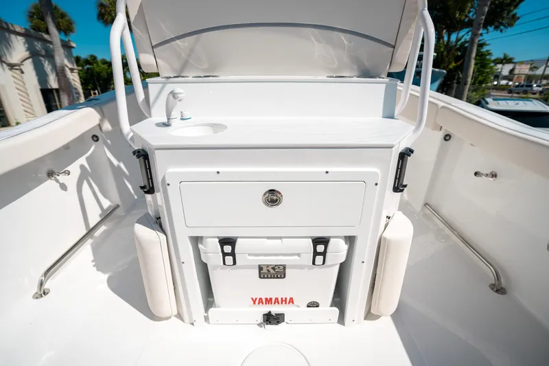 Slide: The Image of 2025 Sea Hunt Ultra 255 SE boat interior with storage and Yamaha cooler. - 15
