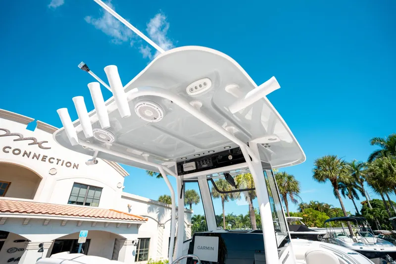 Slide: The Image of 2025 Sea Hunt Ultra 255 SE boat with T-top, clear sky background. - 22