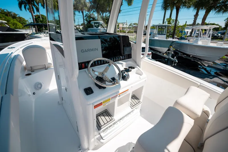 Slide: The Image of 2025 Sea Hunt Ultra 255 SE boat cockpit with Garmin navigation system. - 26