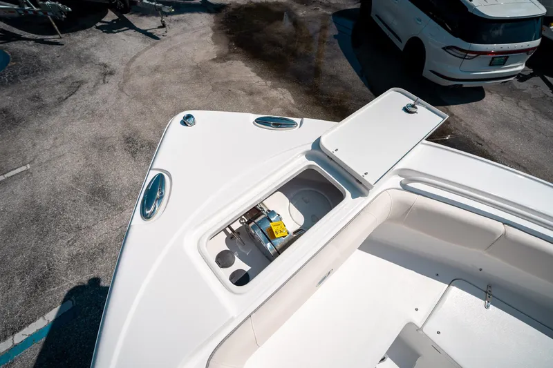 Slide: The Image of 2025 Sea Hunt Ultra 255 SE boat deck with open storage compartment. - 42