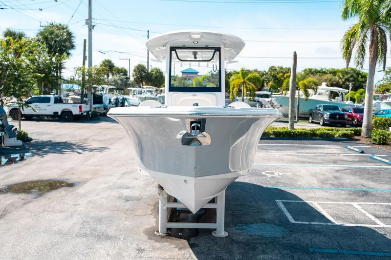 Slide: The Image of 2025 Sea Hunt Ultra 255 SE boat displayed in a sunny parking lot. - 7