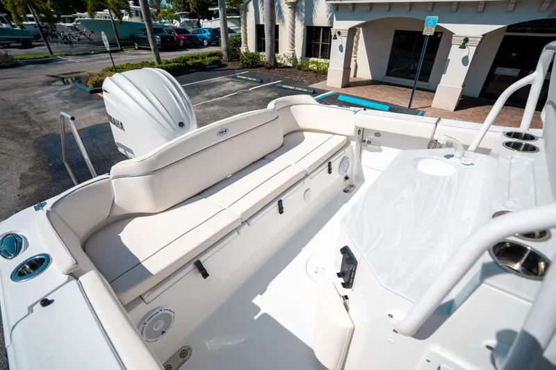 Slide: The Image of 2025 Sea Hunt Ultra 255 SE boat interior with seating and engine view. - 12