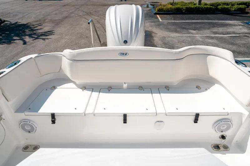 Slide: The Image of 2025 Sea Hunt Ultra 255 SE boat interior with storage compartments and seating. - 13