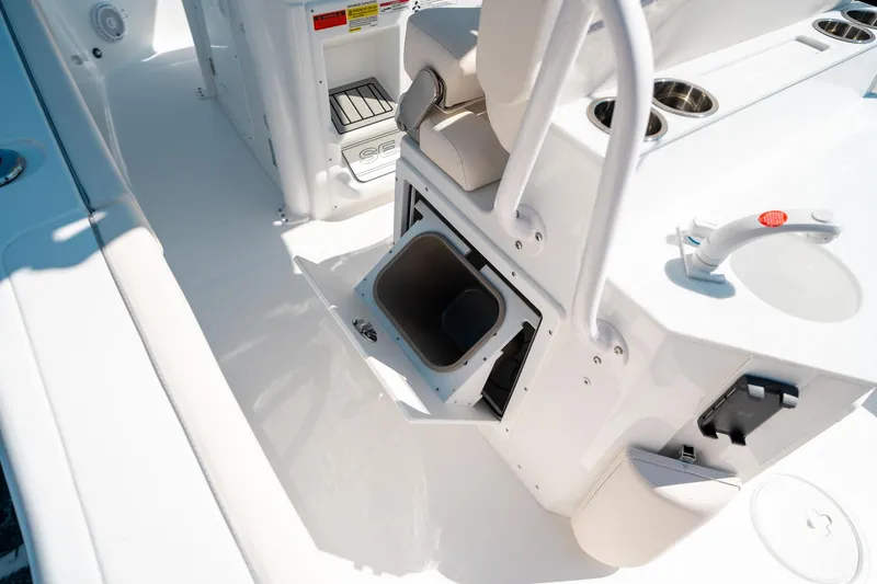 Slide: The Image of 2025 Sea Hunt Ultra 255 SE boat interior with storage compartment and seating area. - 19