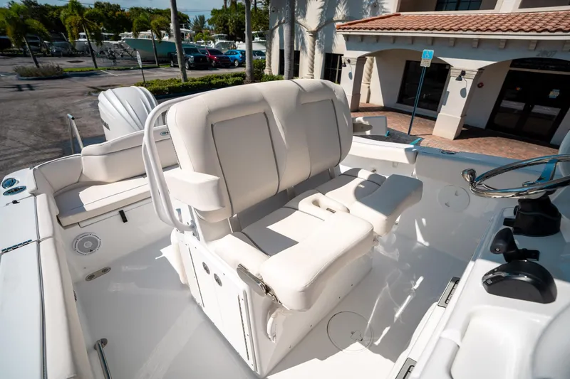 Slide: The Image of 2025 Sea Hunt Ultra 255 SE boat interior with white seating and steering wheel. - 29