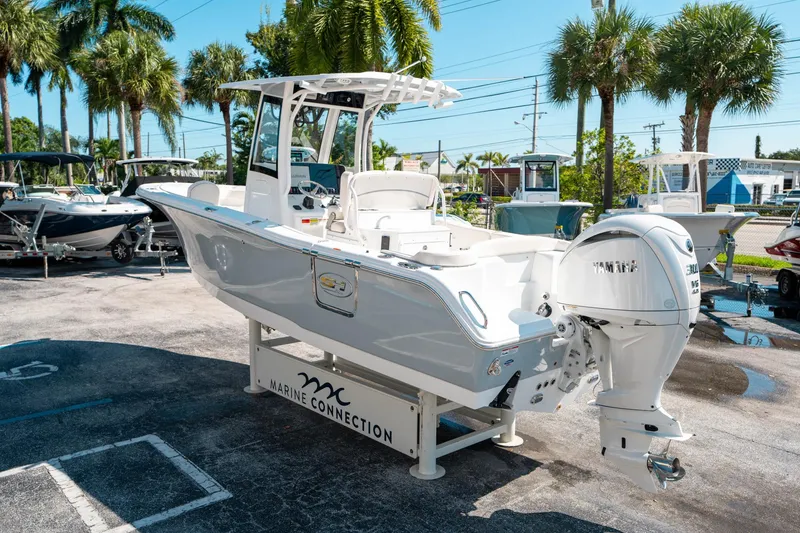 Slide: The Image of 2025 Sea Hunt Ultra 255 SE boat displayed outdoors with palm trees in the background. - 4