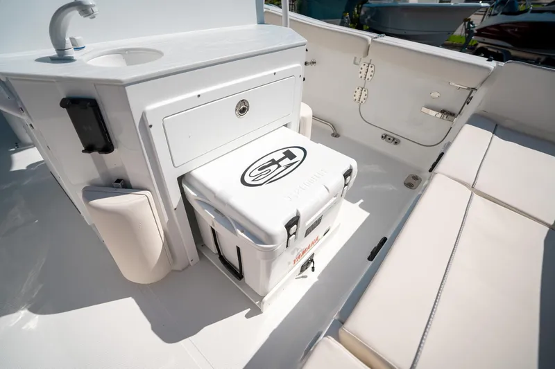 Slide: The Image of 2025 Sea Hunt Ultra 255 SE boat interior with sink and storage area. - 18