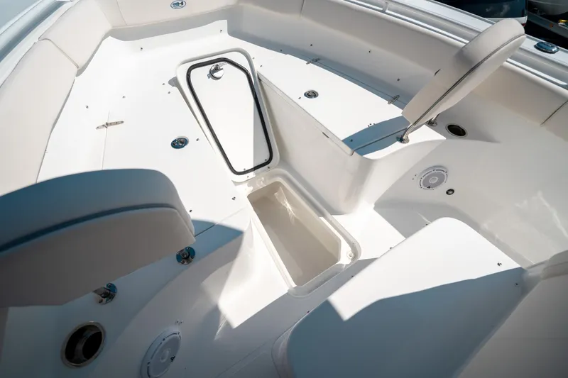 Slide: The Image of 2025 Sea Hunt Ultra 255 SE boat interior with seating and storage compartment. - 40