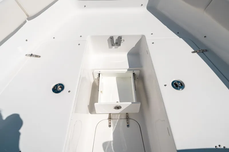 Slide: The Image of 2025 Sea Hunt Ultra 255 SE boat interior with open storage compartment. - 41