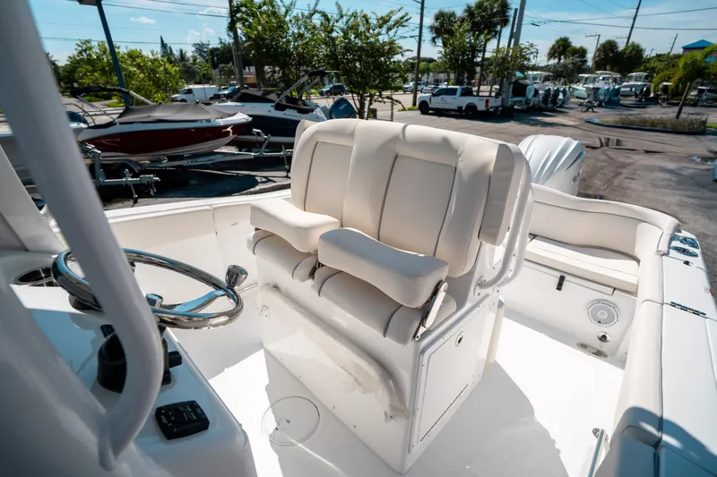 Slide: The Image of 2025 Sea Hunt Ultra 255 SE boat interior with plush seating and steering wheel. - 27