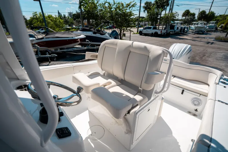 Slide: The Image of 2025 Sea Hunt Ultra 255 SE boat interior with helm and seating area. - 30