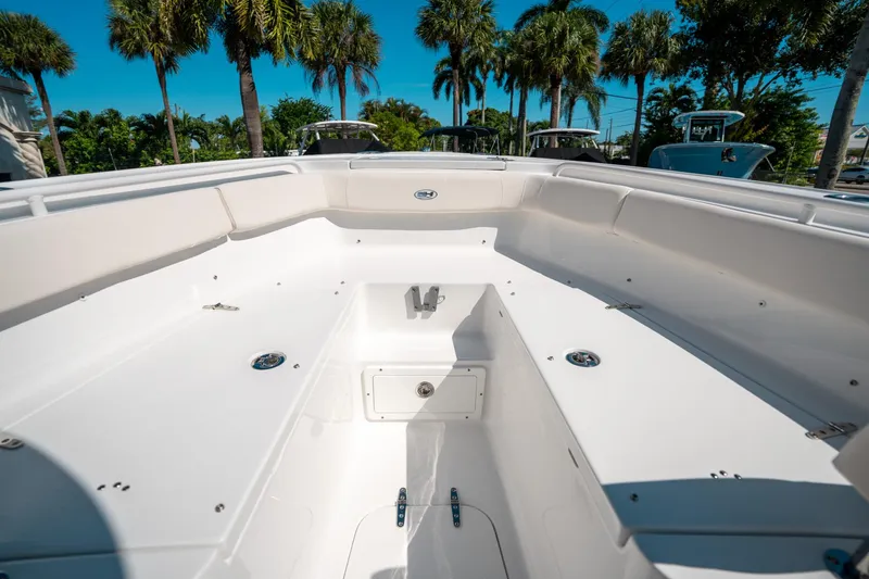 Slide: The Image of 2025 Sea Hunt Ultra 255 SE boat interior with palm trees in the background. - 38