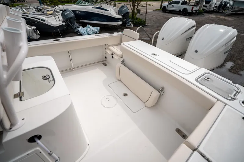 Slide: The Image of 2025 Sea Hunt GAMEFISH 27 CB boat interior with seating and dual Yamaha engines. - 11