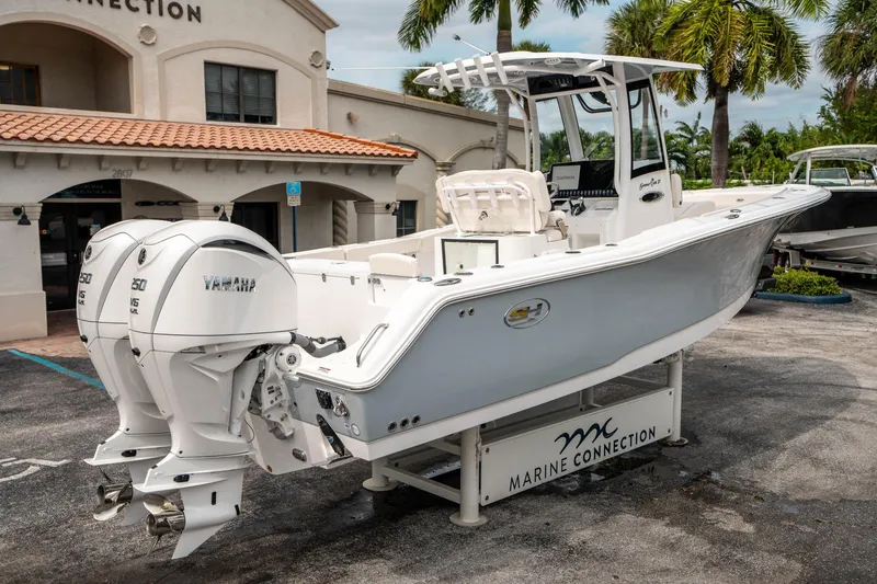 Slide: The Image of 2025 Sea Hunt GAMEFISH 27 CB boat with twin Yamaha engines at Marine Connection dealership. - 2
