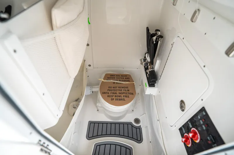 Slide: The Image of Interior of 2025 Sea Hunt GAMEFISH 27 CB boat, featuring a compact restroom area. - 28
