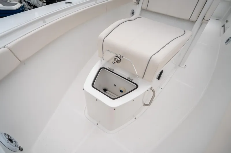 Slide: The Image of 2025 Sea Hunt GAMEFISH 27 CB boat interior with cushioned seating and storage compartment. - 32