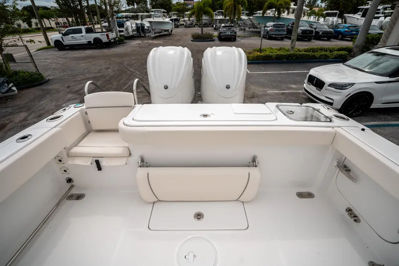 Slide: The Image of 2025 Sea Hunt GAMEFISH 27 CB boat interior with dual engines and seating area. - 10