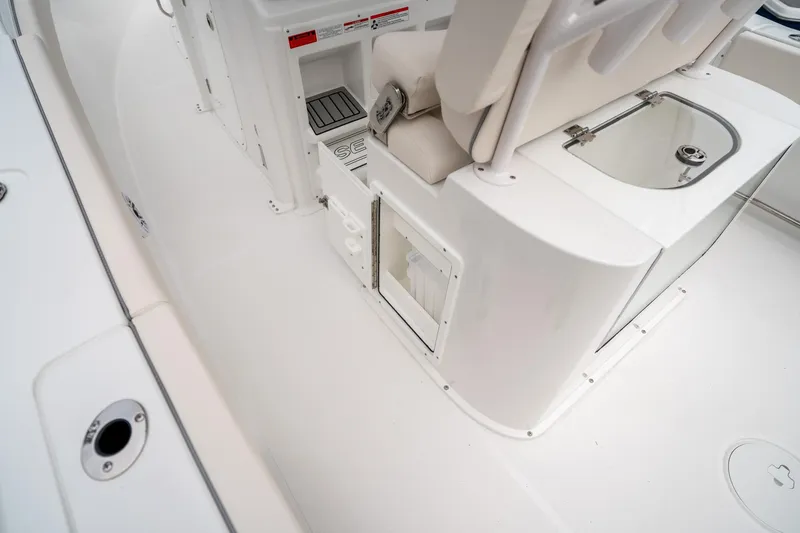 Slide: The Image of 2025 Sea Hunt GAMEFISH 27 CB boat interior, featuring seating and storage compartments. - 20