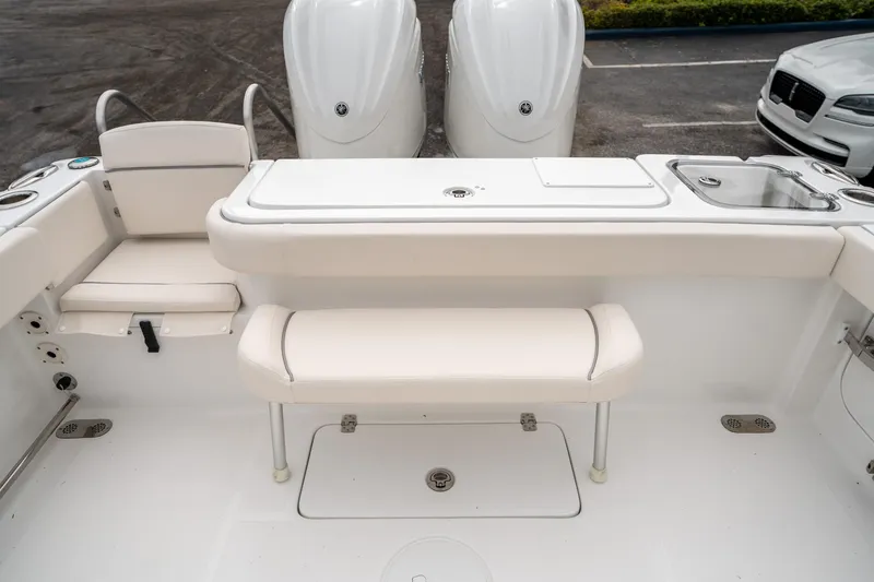 Slide: The Image of 2025 Sea Hunt GAMEFISH 27 CB boat interior with seating and dual engines. - 13