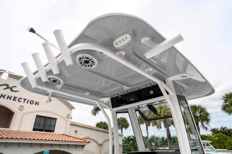 Slide: The Image of 2025 Sea Hunt GAMEFISH 27 CB boat T-top with rod holders and speakers. - 22