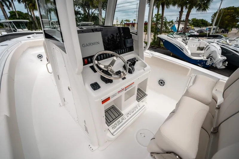 Slide: The Image of 2025 Sea Hunt GAMEFISH 27 CB boat interior with Garmin navigation system and seating. - 25