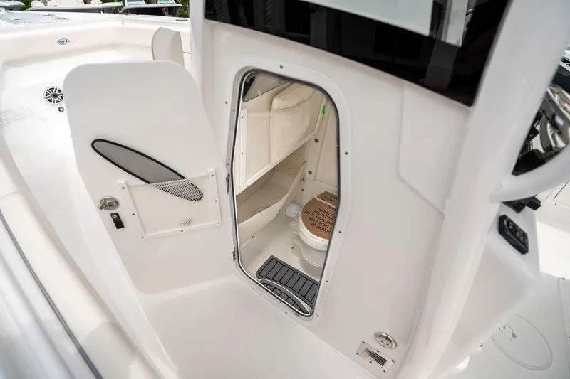 Slide: The Image of 2025 Sea Hunt GAMEFISH 27 CB boat interior with open door revealing compact cabin space. - 27