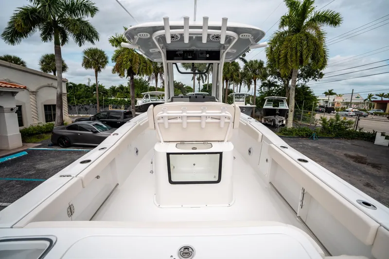 Slide: The Image of 2025 Sea Hunt GAMEFISH 27 CB boat, spacious deck, palm trees in background. - 9