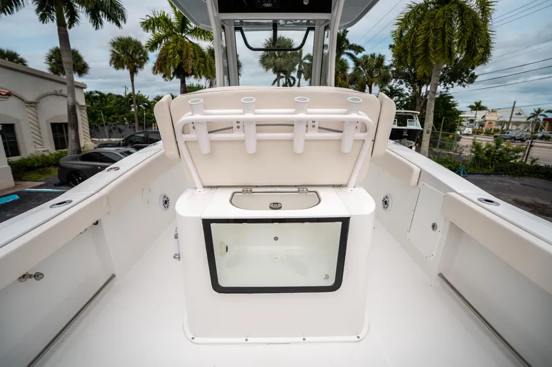 Slide: The Image of 2025 Sea Hunt GAMEFISH 27 CB boat interior with rod holders and storage compartment. - 17