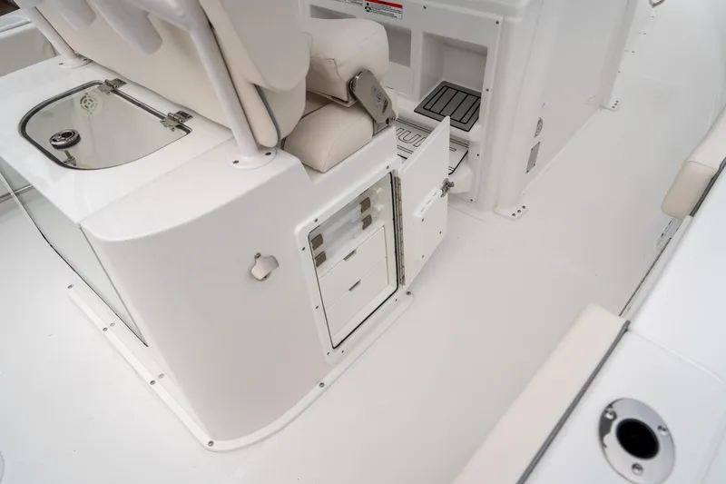 Slide: The Image of 2025 Sea Hunt GAMEFISH 27 CB interior, featuring storage compartments and seating area. - 19