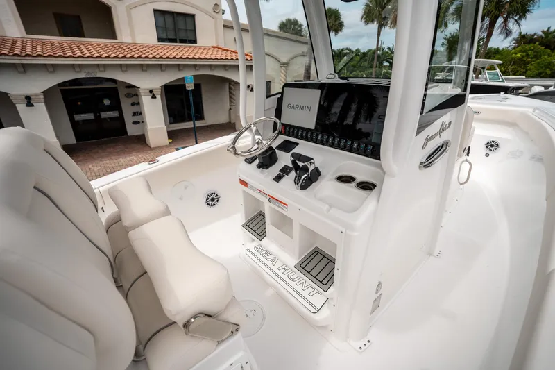 Slide: The Image of 2025 Sea Hunt GAMEFISH 27 CB boat interior with Garmin navigation system and plush seating. - 26