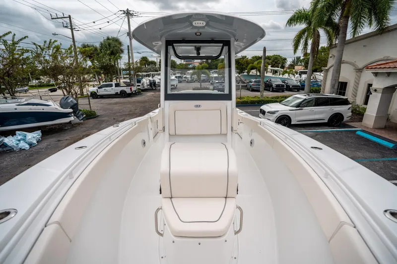 Slide: The Image of 2025 Sea Hunt GAMEFISH 27 CB boat interior, showcasing seating and helm area. - 31
