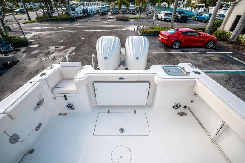 Slide: The Image of 2025 Sea Hunt Gamefish 30 FS boat with dual engines in a parking lot. - 10