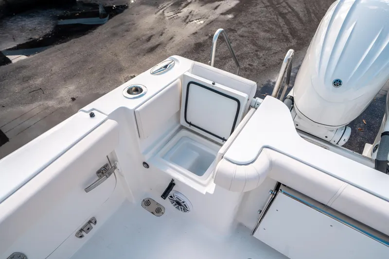 Slide: The Image of 2025 Sea Hunt Gamefish 30 FS boat interior with storage compartment and engine. - 14
