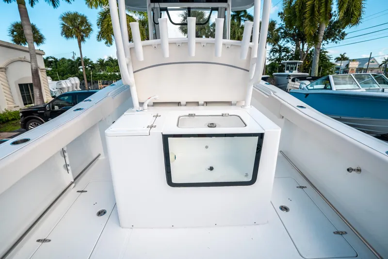 Slide: The Image of 2025 Sea Hunt Gamefish 30 FS boat interior with livewell and rod holders. - 16