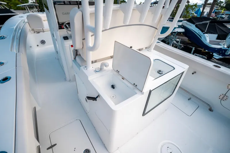Slide: The Image of 2025 Sea Hunt Gamefish 30 FS boat interior with open storage compartment and seating. - 18