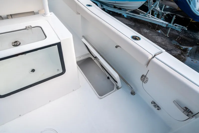 Slide: The Image of 2025 Sea Hunt Gamefish 30 FS boat interior with storage compartment and livewell. - 19