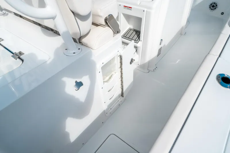 Slide: The Image of 2025 Sea Hunt Gamefish 30 FS boat interior with open storage compartment. - 22