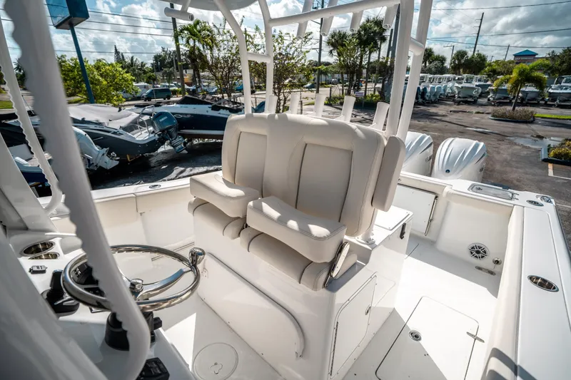 Slide: The Image of 2025 Sea Hunt Gamefish 30 FS boat interior with helm seating and steering wheel. - 26