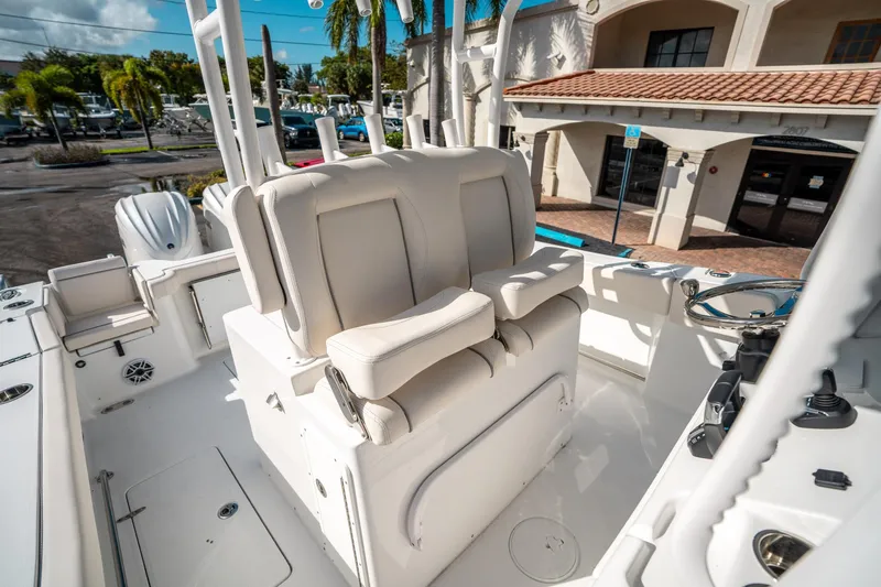 Slide: The Image of 2025 Sea Hunt Gamefish 30 FS boat interior with white seating and steering wheel. - 27