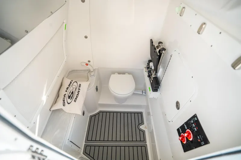 Slide: The Image of Interior of 2025 Sea Hunt Gamefish 30 FS boat, featuring a compact marine toilet. - 31
