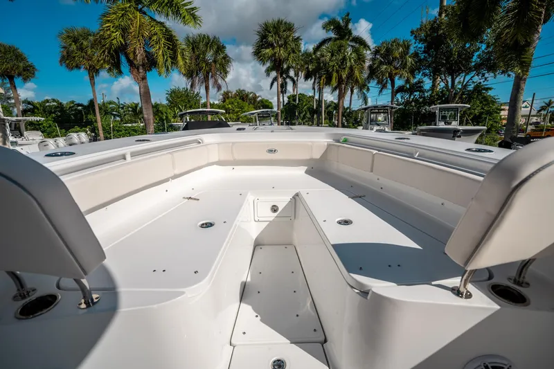 Slide: The Image of 2025 Sea Hunt Gamefish 30 FS boat deck with seating, surrounded by palm trees. - 38
