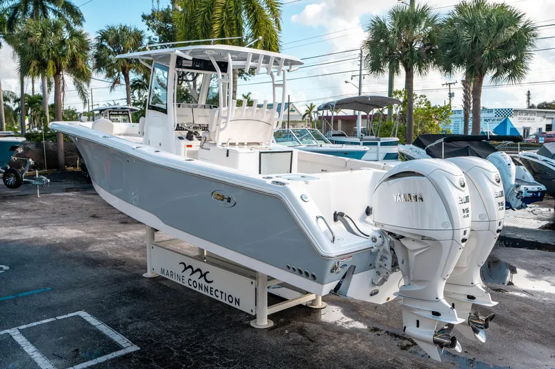 Slide: The Image of 2025 Sea Hunt Gamefish 30 FS boat with dual Yamaha engines, displayed outdoors. - 4