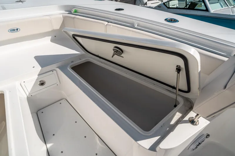 Slide: The Image of 2025 Sea Hunt Gamefish 30 FS boat storage compartment open, showcasing interior space. - 41
