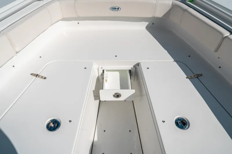 Slide: The Image of 2025 Sea Hunt Gamefish 30 FS boat interior, featuring spacious white seating and storage compartments. - 43
