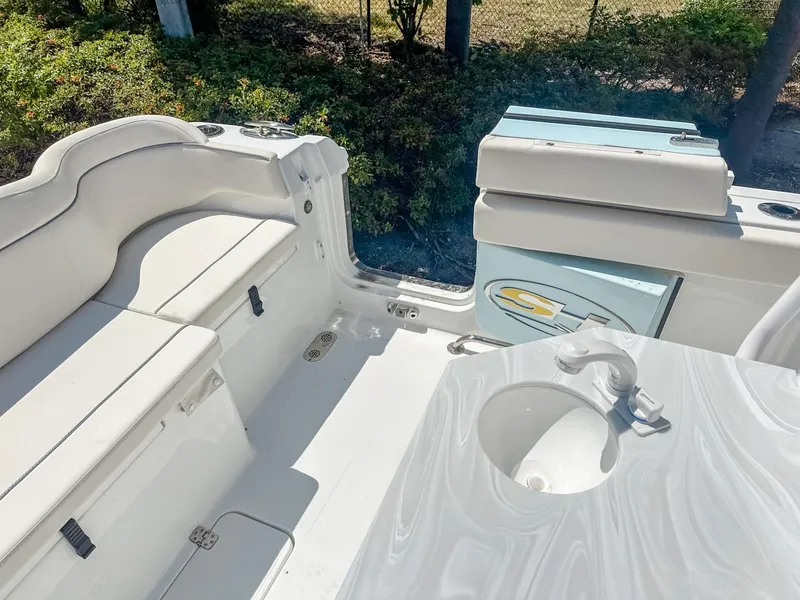 Slide: The Image of 2025 Sea Hunt Ultra 275 SE boat interior with seating and sink. - 11