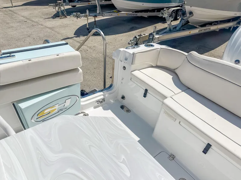 Slide: The Image of 2025 Sea Hunt Ultra 275 SE boat interior with white seating and storage compartments. - 12