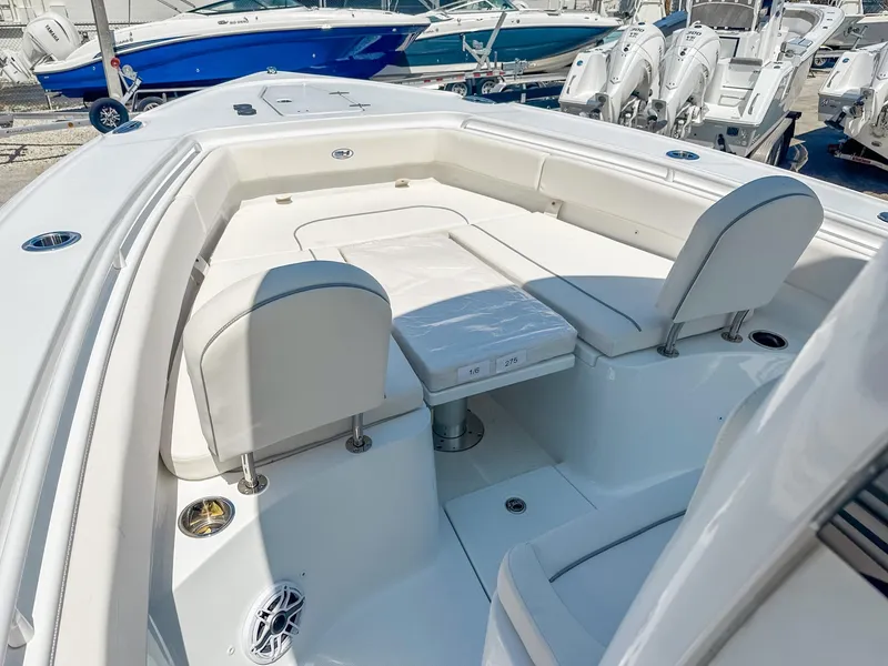 Slide: The Image of 2025 Sea Hunt Ultra 275 SE boat interior with white seating and table. - 22
