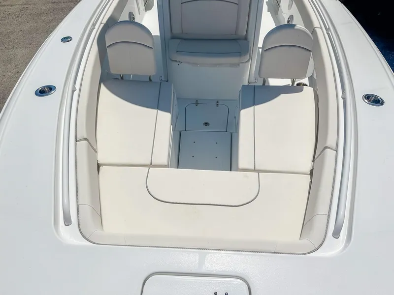 Slide: The Image of 2025 Sea Hunt Ultra 275 SE boat interior with white cushioned seating. - 25