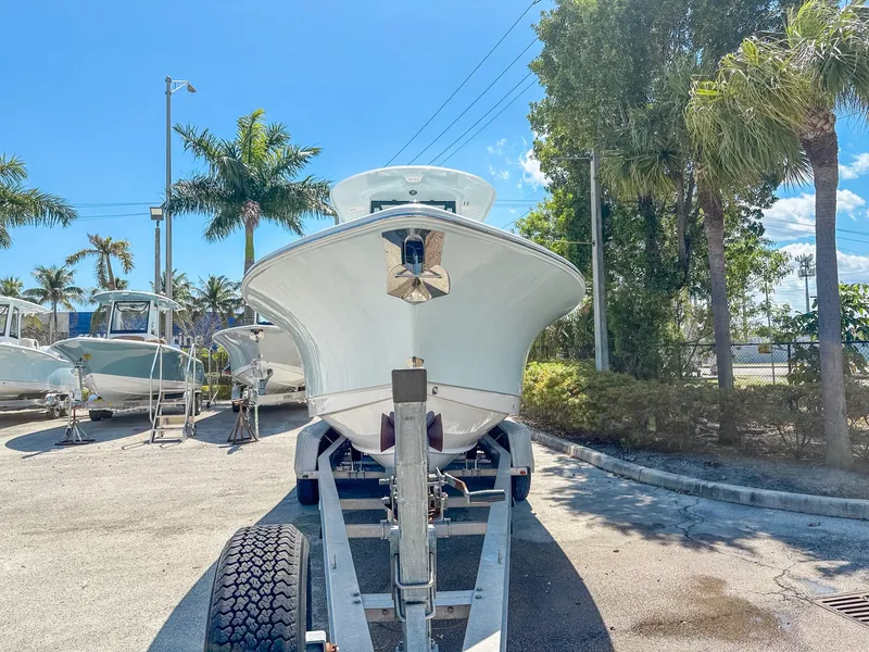 Slide: The Image of 2025 Sea Hunt Ultra 275 SE boat on trailer, surrounded by palm trees. - 3
